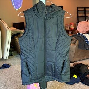 The North Face. Black full sip hooded vest. Two zip pockets. Size small.